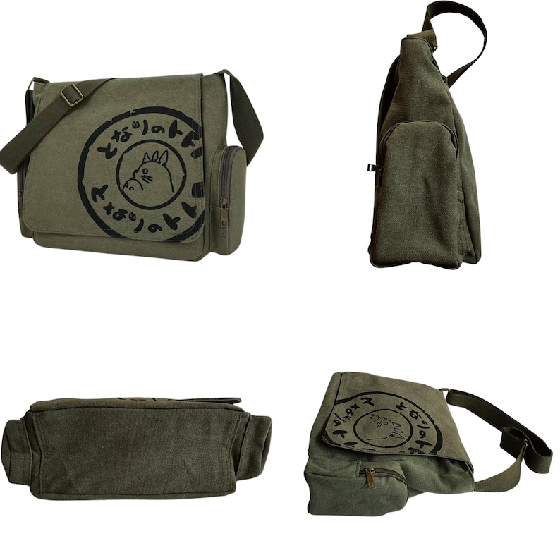 May include: Olive green canvas messenger bag with a flap closure, adjustable shoulder strap, and a small side pocket. The bag features a black circular graphic with Japanese text and a cartoon character.