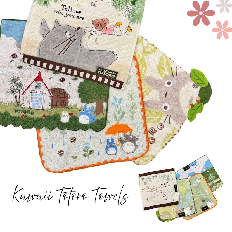 May include: A collection of colorful, decorative towels featuring illustrations of characters from the animated film "My Neighbor Totoro." The towels have various designs, including Totoro, houses, and nature scenes. The text "Tell me who you are" is visible.