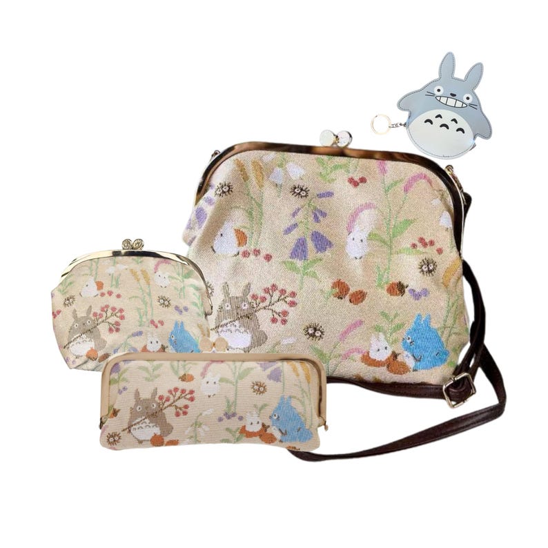 May include: A set of beige fabric bags with a floral and cartoon character design. The set includes a purse, a coin purse, a pencil case, and a small keychain. The bags have brown straps and metal clasps.