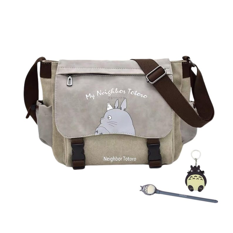 May include: A canvas messenger bag with a flap featuring a gray Totoro illustration and the text "My Neighbor Totoro". The bag has brown accents, a shoulder strap, and two black buckles. A Totoro keychain and a pen are included.