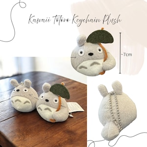 K&ouml;nnte beinhalten: Kawaii Totoro Schl&uuml;sselanh&auml;nger Pl&uuml;sch, ca. 7 cm gro&szlig;. Das Pl&uuml;schtier ist grau und wei&szlig; mit einem gr&uuml;nen Blattschirm und orangefarbenen Akzenten. Der Schl&uuml;sselanh&auml;nger besteht aus weichem Material und hat eine silberne Kette.