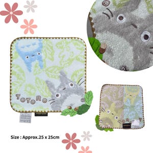 May include: Square, light green and white Totoro-themed washcloths. The washcloths feature a cartoon Totoro character and the word "Totoro". The washcloths are approximately 9.8 inches by 10 inches.