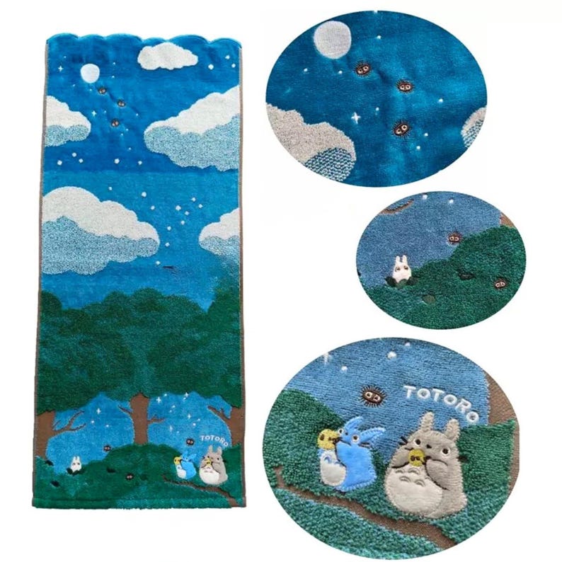 May include: A blue and green decorative rug featuring a whimsical forest scene with clouds, stars, and the word "TOTORO". The rug has a scalloped edge and depicts characters from the animated film.