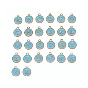 May include: A collection of gold-colored metal alphabet charms with a light blue enamel finish. Each charm features a different letter from A to Z, perfect for jewelry making or personalized crafts. The charms are round with a small loop at the top.