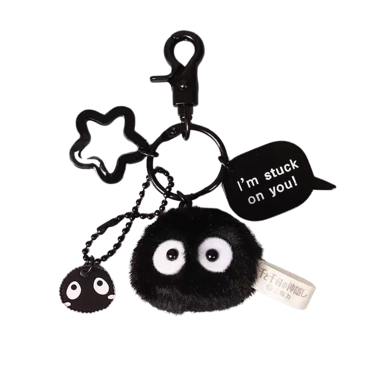 May include: Black plush keychain with a fuzzy black ball with white eyes, a metal star charm, a metal ring, and a metal tag that says "I'm stuck on you!"