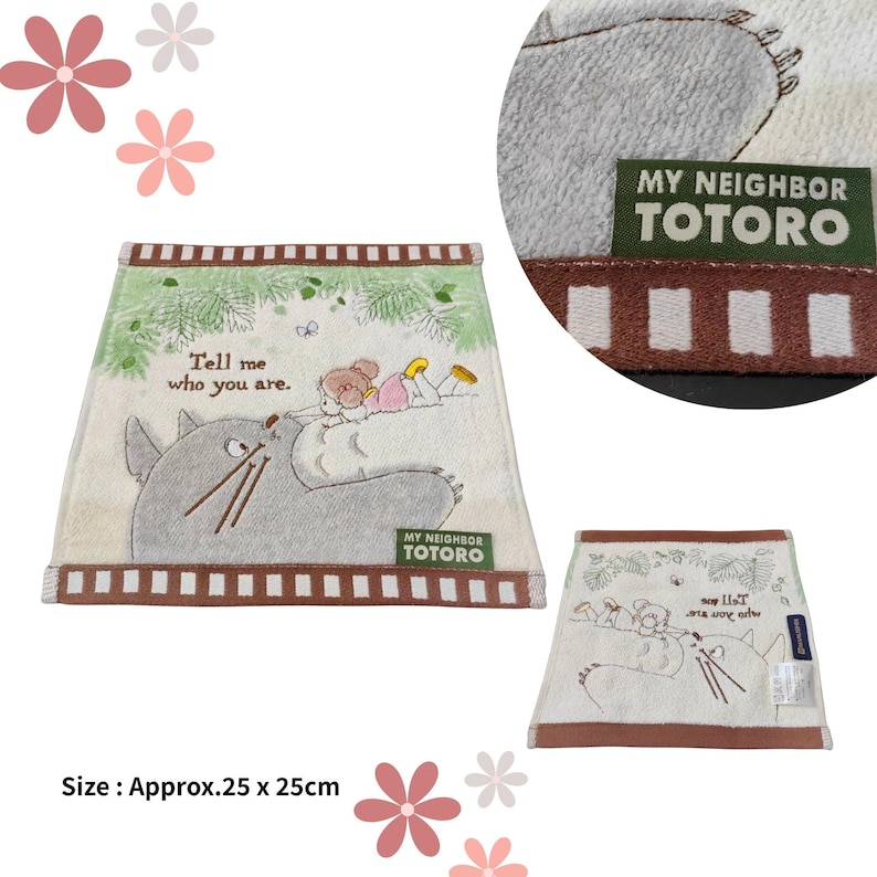 May include: A beige My Neighbor Totoro themed towel, approximately 9.8 x 9.8 inches, featuring an illustration of Totoro and a girl. The towel has a brown border and the text "Tell me who you are."