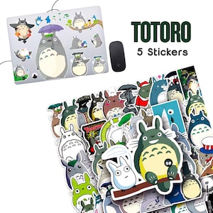 May include: A collection of Totoro stickers featuring various characters from the animated film. The stickers are in different sizes and poses, with a laptop covered in Totoro stickers in the background. The text "TOTORO 5 Stickers" is displayed.