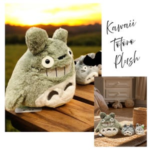 May include: A plush toy of a Totoro character, in shades of gray and white, with large eyes and a wide grin. The image includes the text "Kawaii Totoro Plush". The plush is on a wooden surface with a blurred background of a sunset.