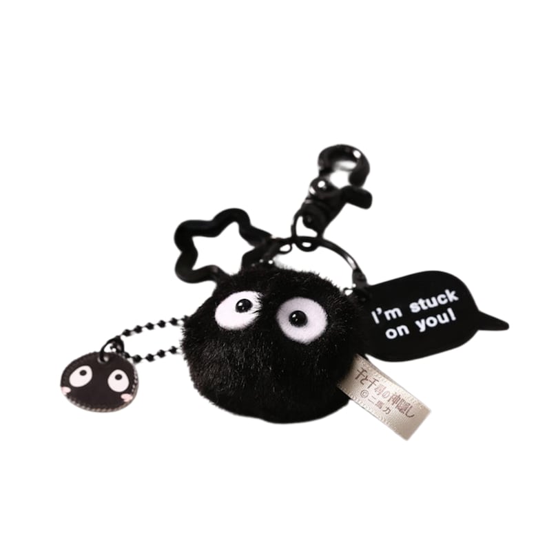 May include: Black plush keychain with a round, fuzzy black character with white eyes. The keychain has a metal ring and a black tag that says "I'm stuck on you!"
