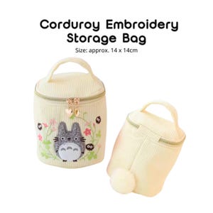 May include: Two cream-colored corduroy storage bags with zipper closures and handles. One bag features an embroidered cartoon character with floral accents. The text "CORDUROY EMBROIDERY STORAGE BAG" is above the bags. Size: approx. 5.5 x 5.5 inches.