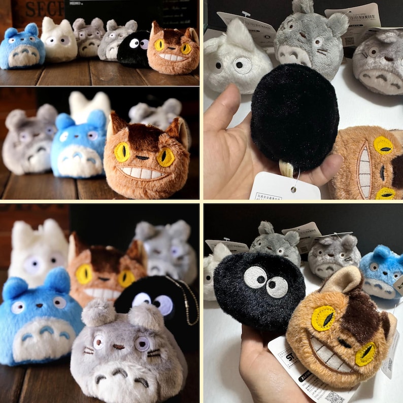 May include: A collection of plush toys in various colors and designs, including blue, white, gray, brown, and black. The toys feature cartoon cat-like characters with large eyes and smiles. Some have keychains attached.