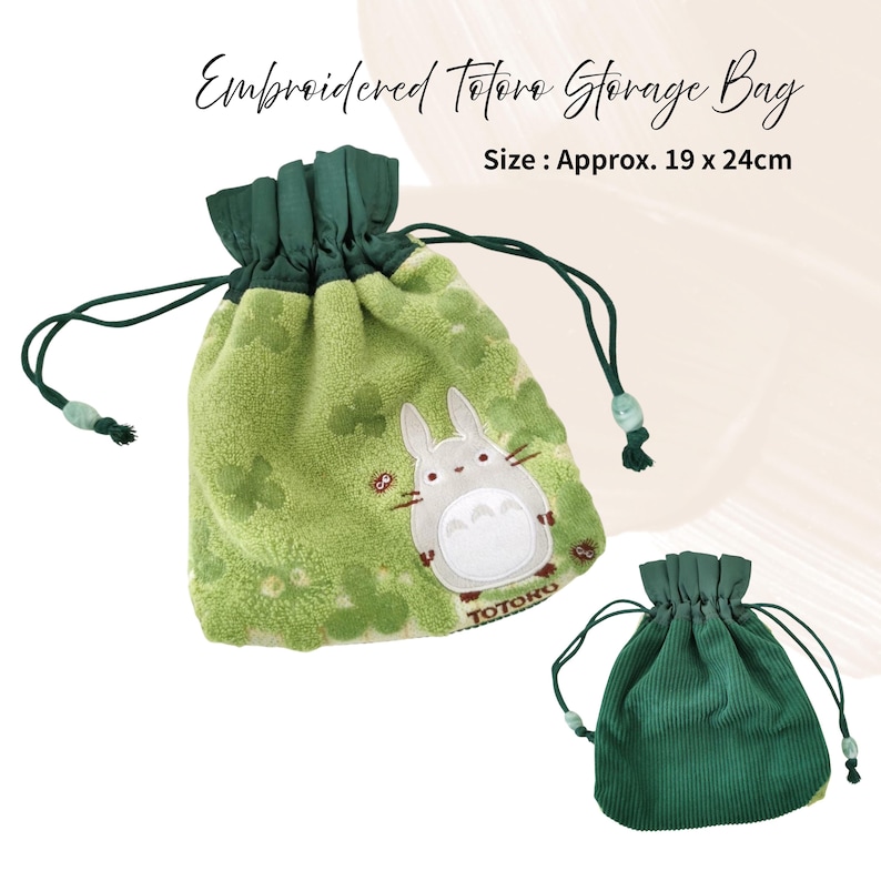 May include: Embroidered Totoro storage bag, approx. 19 x 24cm. The green bag features a Totoro character design and a drawstring closure. A smaller, solid green bag is also shown.