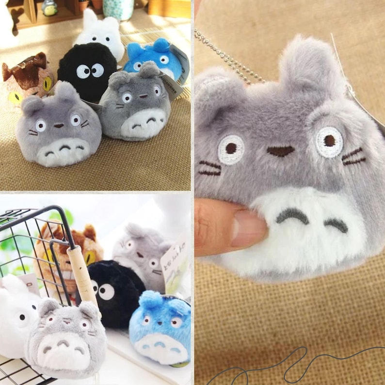 May include: A collection of plush character toys in various colors, including gray, blue, white, and black. The toys have embroidered facial features and are designed to resemble cartoon characters. Some toys are attached to keychains.