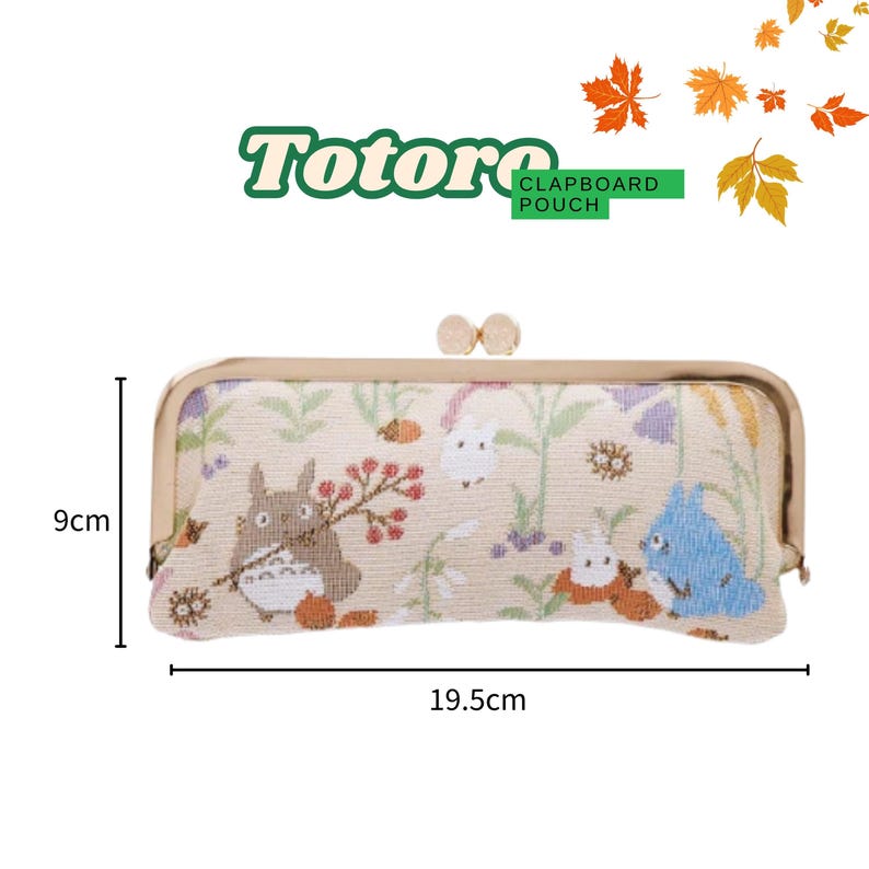 May include: A beige claptboard pouch with a gold clasp, featuring a Totoro design. The pouch is 19.5cm long and 9cm high. The design includes illustrations of Totoro and other characters, with floral and leaf accents.
