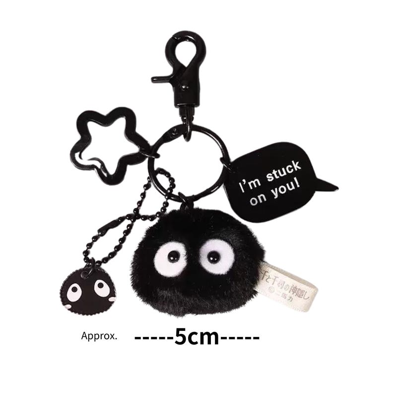 May include: Black plush keychain featuring a character with large eyes and a speech bubble that reads "I'm stuck on you!" The keychain is approximately 5 inches long.