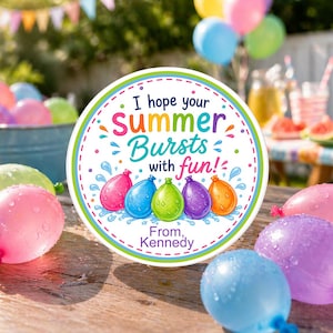 May include: A round, colorful sign with the text "I hope your Summer Bursts with fun!" and the name "Kennedy". The sign features illustrations of water balloons in pink, blue, green, purple, and orange. Water balloons and other balloons are scattered around the sign.