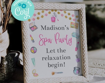 May include: A white framed sign with a pink and gold background. The sign says "Madison's Spa Party" and "Let the relaxation begin!" with images of makeup and beauty products.