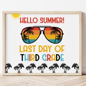 May include: A white sign with a wood frame, featuring a retro-style illustration of sunglasses with palm trees reflected in the lenses. The text "HELLO SUMMER!" is above the sunglasses, and "LAST DAY OF THIRD GRADE" is below. A row of palm trees is at the bottom of the sign.