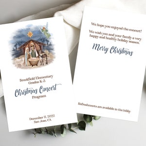 Peut inclure: Programme de concert de Noël en deux pages. La face avant présente une illustration à l'aquarelle de la scène de la Nativité. Le texte indique "Brookfield Elementary Christmas Concert Program" et la date. Le dos dit "Joyeux Noël".