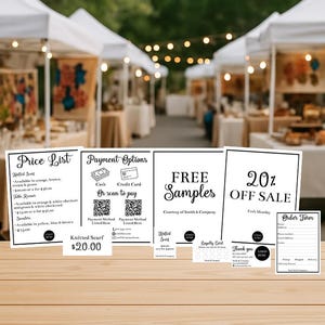 May include: An outdoor market scene with several white tents. In the foreground, there are several signs with text, including a price list, payment options, and a sign that says "Free Samples". A sign indicates a knitted scarf for $20.00.