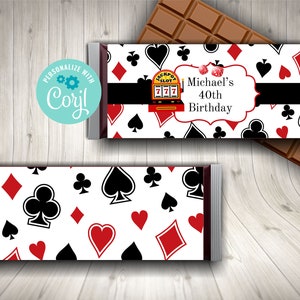 May include: A white chocolate bar wrapper with a red, black, and white playing card pattern. The wrapper has a black banner with the text "Michael's 40th Birthday".