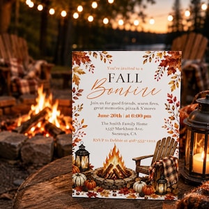 May include: A rectangular invitation card featuring a fall bonfire theme with watercolor autumn leaves, a stone fire pit, wooden chairs, and lanterns. The text reads: You're invited to a FALL Bonfire, June 20th at 6:00 pm, The Smith Family Home.