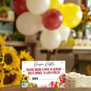 May include: A white card with red and gold stars, a red and white checkered background, and a grill, ketchup, mustard, and a hamburger. The text on the card reads "Diaper Raffle" and "Please bring a pack of diapers for a chance to win a prize!" There is a blank line for a name.