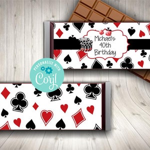 May include: A white chocolate bar wrapper with a red, black, and white playing card pattern. The wrapper has a black banner with the text "Michael's 40th Birthday".