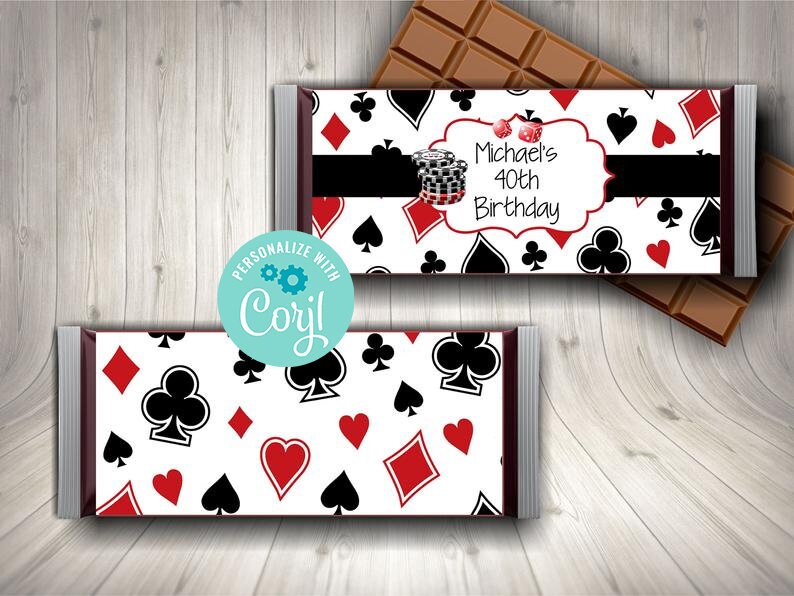 May include: A white chocolate bar wrapper with a red, black, and white playing card pattern. The wrapper has a black banner with the text "Michael's 40th Birthday".