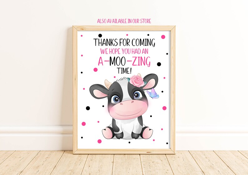 May include: A white sign with black polka dots and pink polka dots. The sign says "Thanks for coming. We hope you had an A-Moo-Zing time!" and features a cartoon black and white cow with a pink flower in its hair and a blue butterfly.