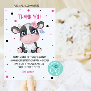 May include: Thank you card with a cute cartoon cow wearing a pink flower. The card has a pink and black polka dot background and says "Thank You" in pink letters. The text reads "Thanks so much for coming to my party and making my 1st birthday party so special! I love the gift you gave me and can't wait to use it very soon. Love, Kennedy".