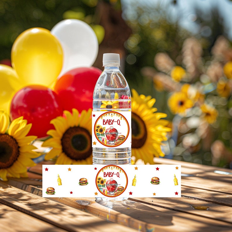 May include: Water bottle label with a red, yellow and white design. The label says "Baby-Q" and features a grill, a hamburger and a bottle of ketchup. The label also has yellow stars and a white background.