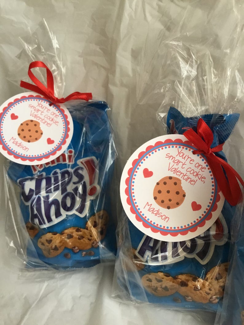 May include: Two bags of Chips Ahoy chocolate chip cookies with a red ribbon and a Valentine's Day tag that says "You're one smart cookie Valentine!" with a chocolate chip cookie graphic and the name "Madison".