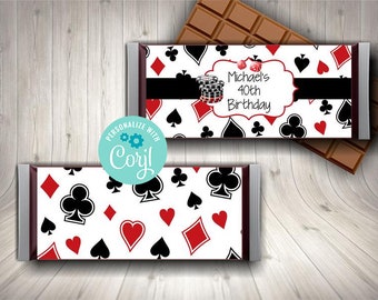 May include: A white chocolate bar wrapper with a red, black, and white playing card pattern. The wrapper has a black banner with the text "Michael's 40th Birthday".