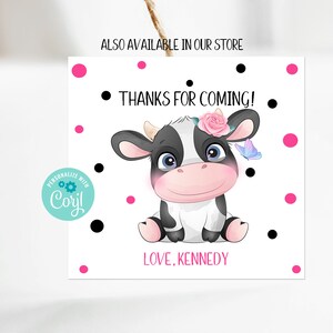 May include: A white thank you card with black polka dots and pink dots. A cartoon cow with a pink flower crown and a blue butterfly is in the center of the card. The text on the card reads "Thanks for coming! Love, Kennedy".