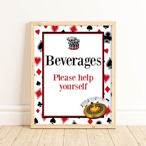 May include: A framed sign with a white background and red and black playing card symbols. The sign says "Beverages Please help yourself" with a casino chip stack and a roulette wheel graphic.