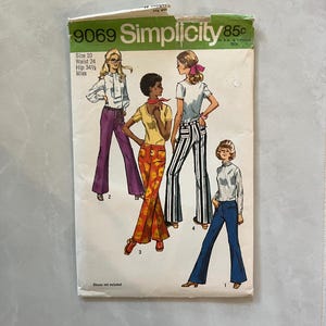 May include: A vintage Simplicity sewing pattern envelope 9069 for size 10, waist 24, hip 34.5. The cover features illustrations of four outfits including a white blouse with purple pants, a yellow top with floral pants, a white tee with striped pants, and a striped top with blue pants.