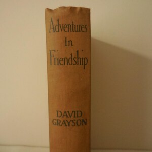May include: A brown book with the title "Adventures in Friendship" by David Grayson.