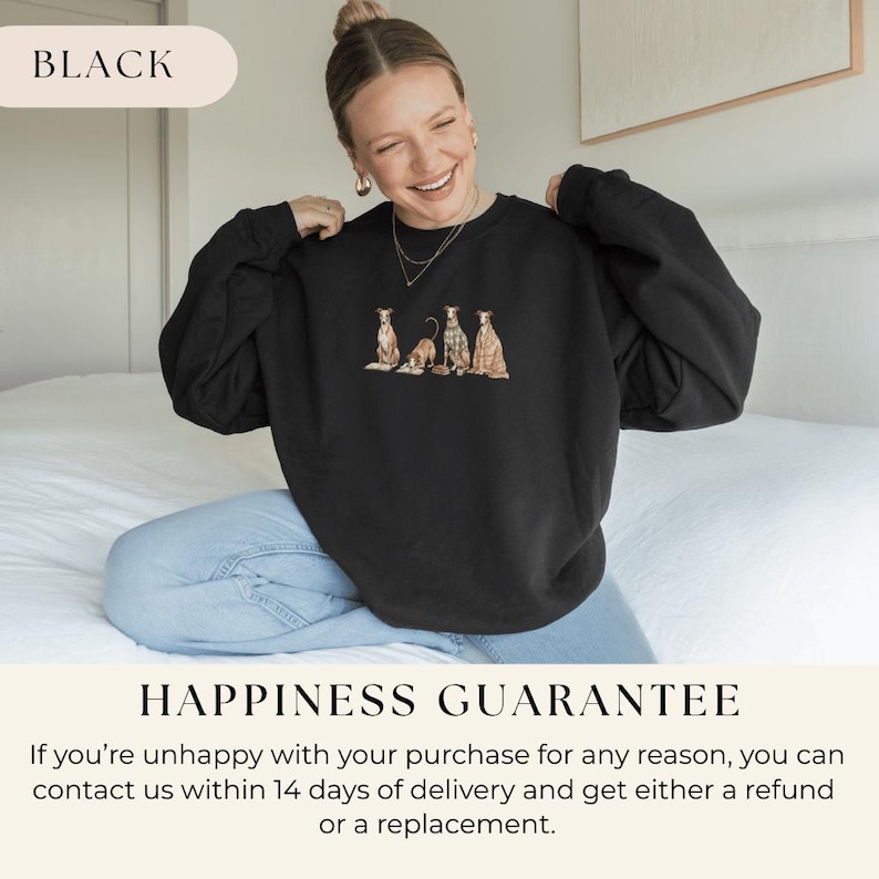 May include: Black sweatshirt featuring an embroidered design of four dogs in various poses. The sweatshirt has long sleeves and a crew neck. The word "BLACK" is printed at the top. The text "HAPPINESS GUARANTEE" is printed at the bottom.