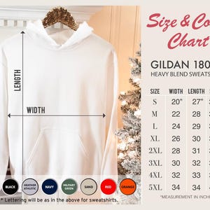 May include: A white hooded sweatshirt, displayed on a wooden hanger. The image includes a size and colour chart with measurements in inches. The sweatshirt is a Gildan 18000 heavy blend. Colour options include white, black, and red.