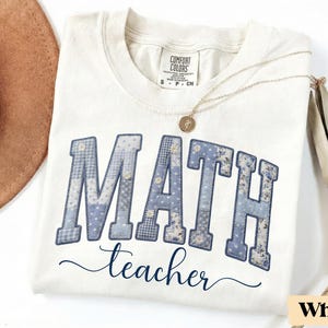 May include: A set of three ceramic mugs with a speckled, matte finish. The mugs are in shades of cream, light gray, and dark gray. Each mug has a simple, minimalist design and a rounded handle.