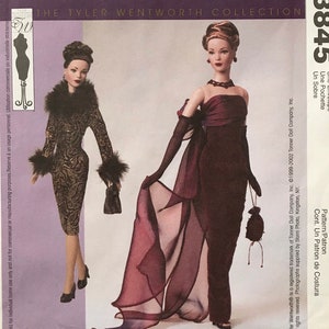 May include: A McCall's Crafts sewing pattern envelope 3845 for The Tyler Wentworth Collection. The front shows two dolls: one in a dark patterned dress with fur trim, and one in a strapless dark gown with sheer fabric and long gloves.
