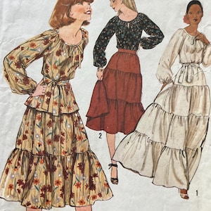 May include: Vintage Simplicity sewing pattern 8305 for Misses' dresses. The illustration shows three different dress styles, including a tiered maxi dress and a long-sleeved dress with a tiered skirt. The pattern is size 12.