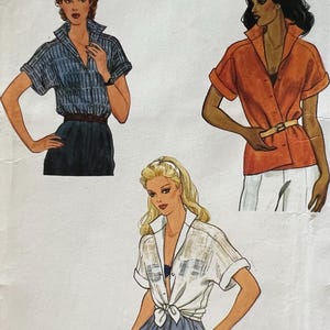 May include: Vogue Very Easy pattern featuring illustrations of three different short-sleeved button-down shirts. The shirts are in blue, orange, and white. The pattern includes the text "Vogue" and "Very Easy". The price is $4.00.