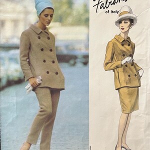May include: Vogue Couturier Design pattern featuring a Fabiani of Italy design. The cover shows a woman in a tan double-breasted coat and pants, and a sketch of a woman in a matching suit. The text "1428" is visible.