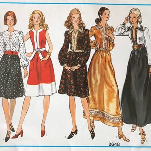 May include: Vogue's Basic Design sewing pattern featuring five vintage fashion illustrations. The designs include dresses with various sleeve lengths, patterns, and colors, including polka dots, floral prints, and solid colors. The pattern number is 2648.