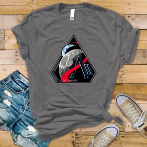 May include: A handmade, wooden cutting board with a natural finish. The board features a live edge, showcasing the wood's unique grain and shape. It's ideal for food preparation and serving.