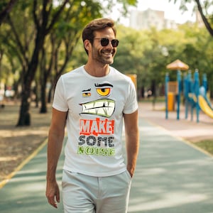 FAI UN PO' DI RUMORE, T-shirt grafica divertente con faccia da cartone animato