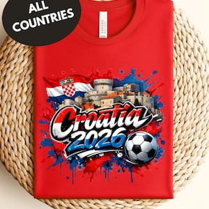 A red t-shirt with a graphic design featuring the text "Croatia 2020" and a soccer ball, along with a flag and splatter-like elements.