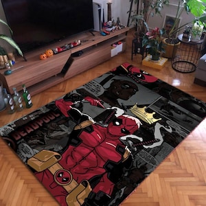 May include: A black and red rug with a comic book design featuring Deadpool, a superhero character. The rug has a black background with white and gray comic book panels. Deadpool is depicted in a red and black suit with a gold belt and a red mask. The rug also features a crown and the word "Deadpool" in white letters.